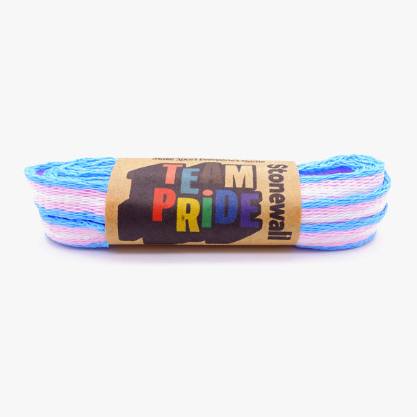 A pair of laces in the colours of the trans (transgender) pride flag, with Stonewall Rainbow Laces paper packaging holding them together