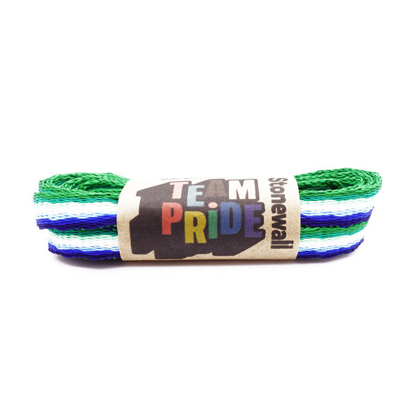 A pair of laces in the colours of the MLM (Men Loving Men) pride flag, with Stonewall Rainbow Laces paper packaging holding them together